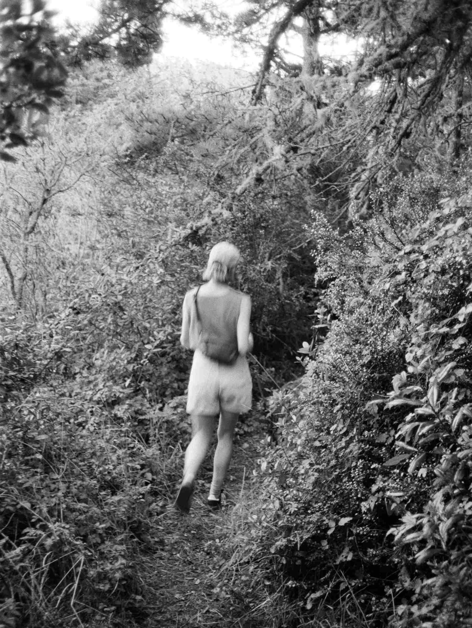 artist portrait, walking through the woods, black and white photograph