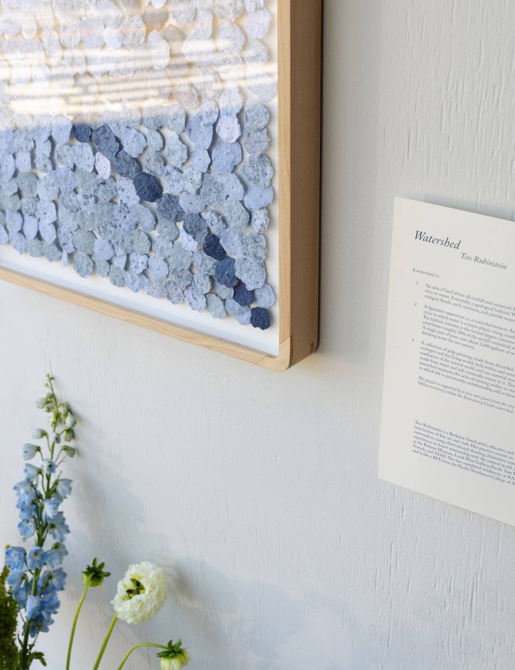 close up of artist statement and weaving piece installed at the watershed exhibtion