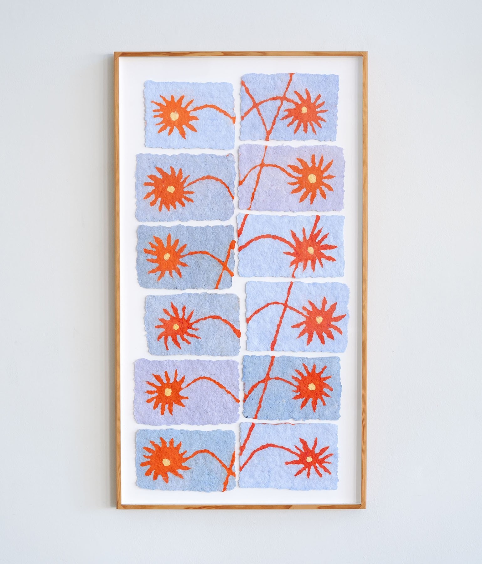 paper pulp painting of red flowers made from recycled cotton t-shirts